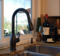 Stainless steel kitchen sink with bronze faucet