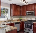 Cherry kitchen cabinets with gray walls