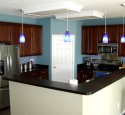Cherry kitchen cabinets with blue walls