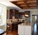 Cherry kitchen cabinets with white island